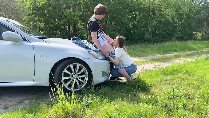 A young college student engages in outdoor sex with a car as a backdrop