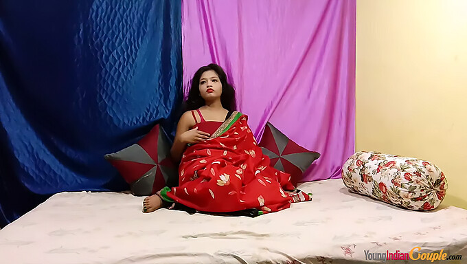 A young Indian woman in a red sari pleasures herself by fingering her vagina, rubbing her clitoris, and achieving orgasm